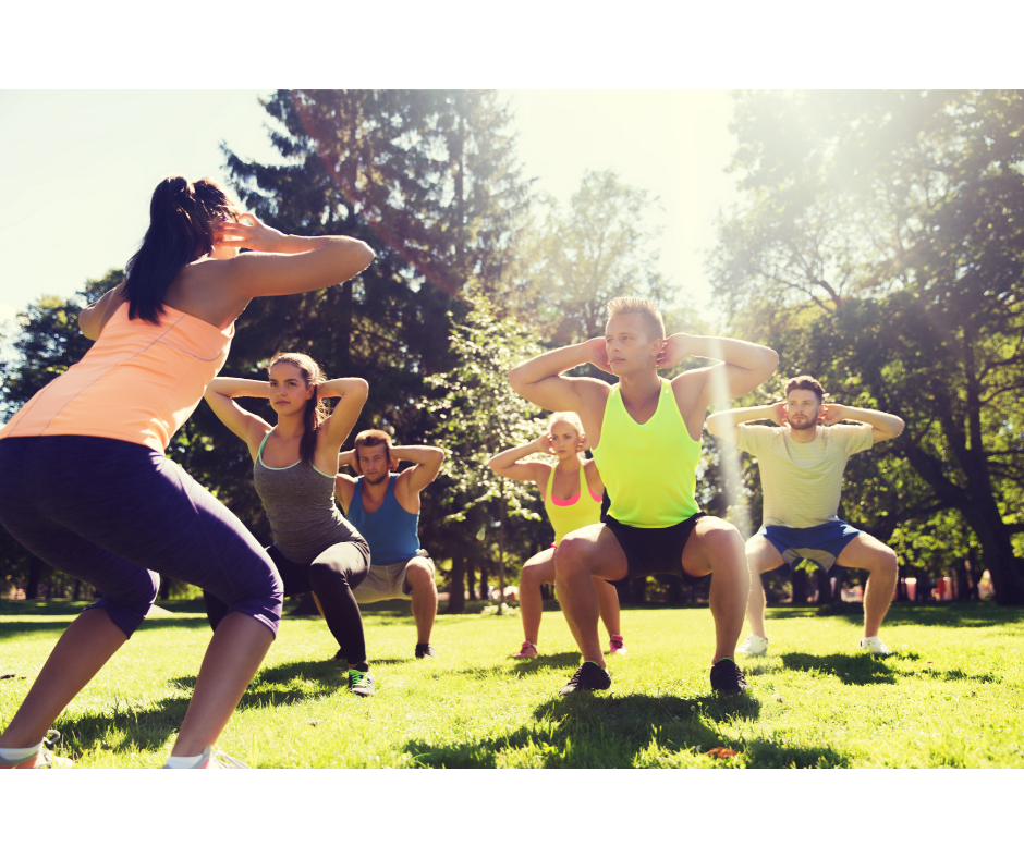 diverse group of people participating in a bootcamp workout outdoors, with a focus on camaraderie and determination.