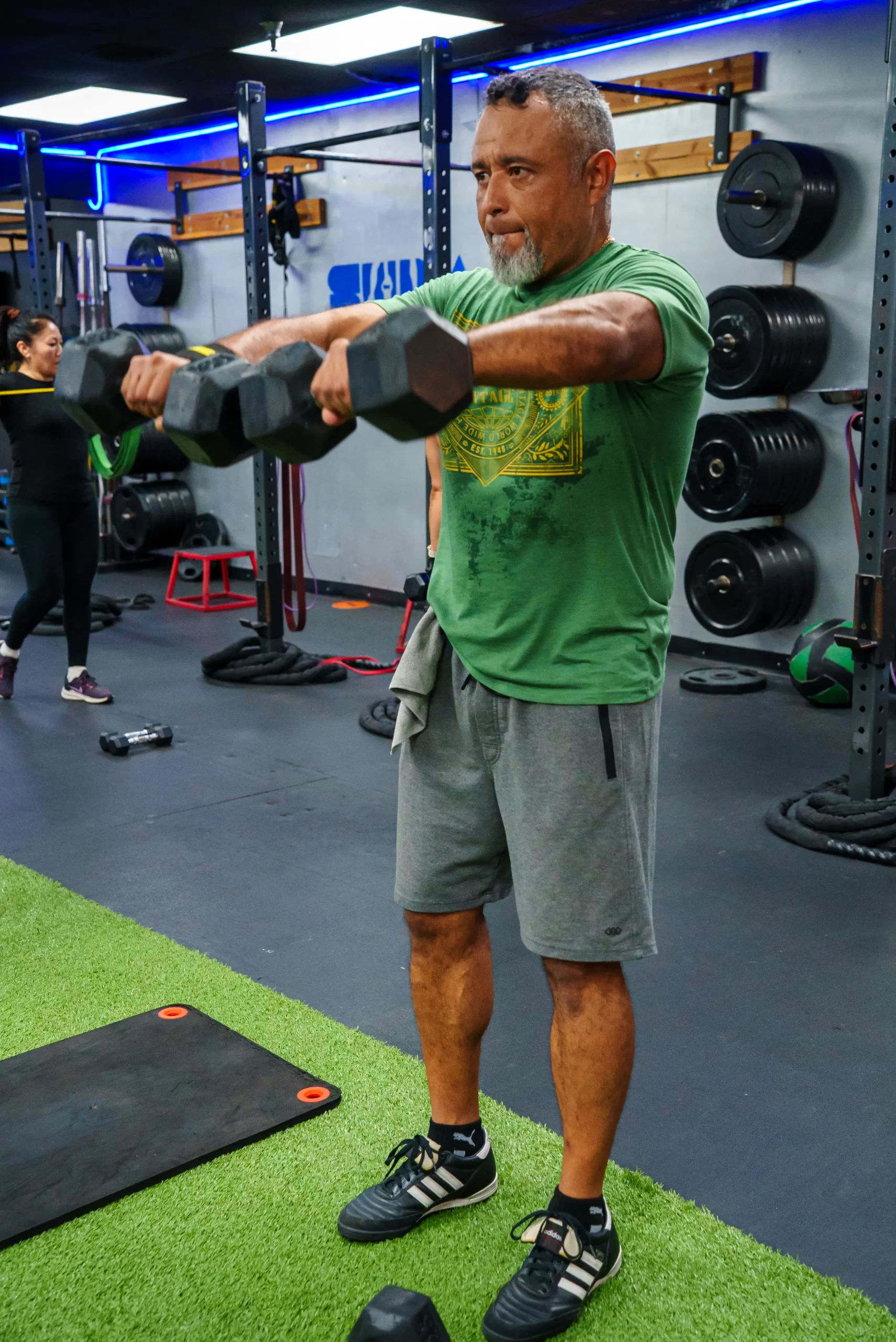 Man completing a strength training workout using dumbbells at SUDA Fitness in Downey, California.
